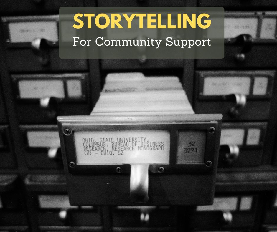 Black-and-white photo of a vintage library card catalog drawer pulled open, with rows of labeled drawers in the background. A translucent banner at the top reads “STORYTELLING” in yellow and “For Community Support” in white text.
